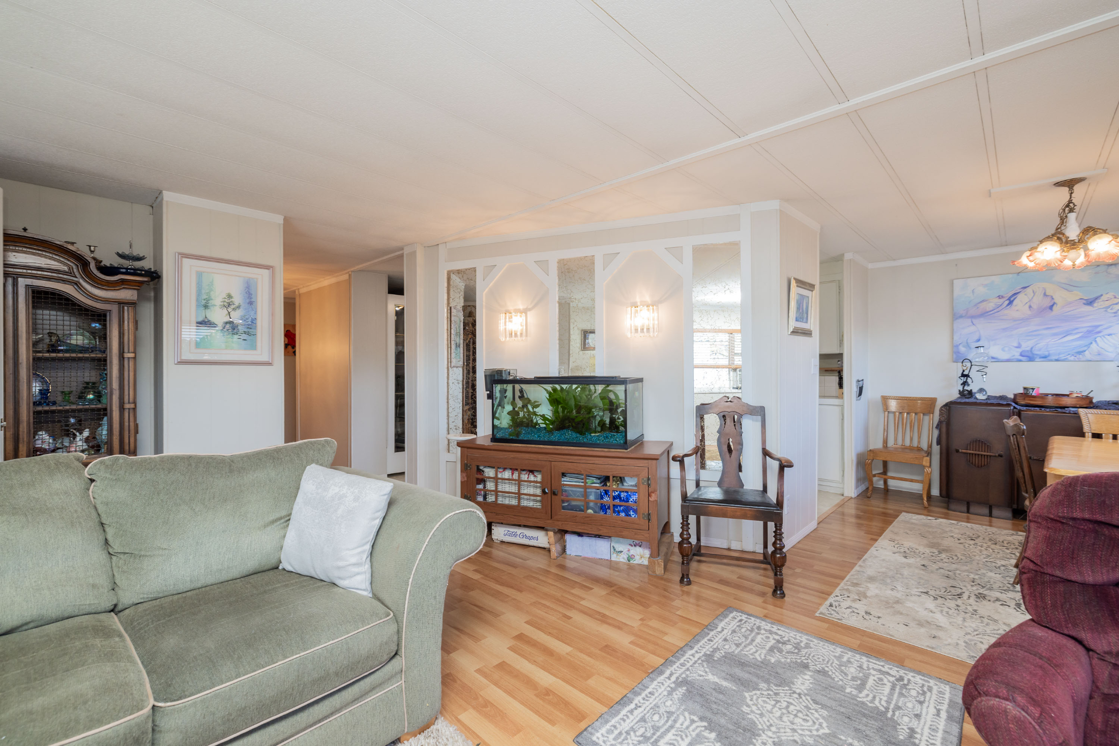 Living area featuring light wood finished floors and an inviting chandelier