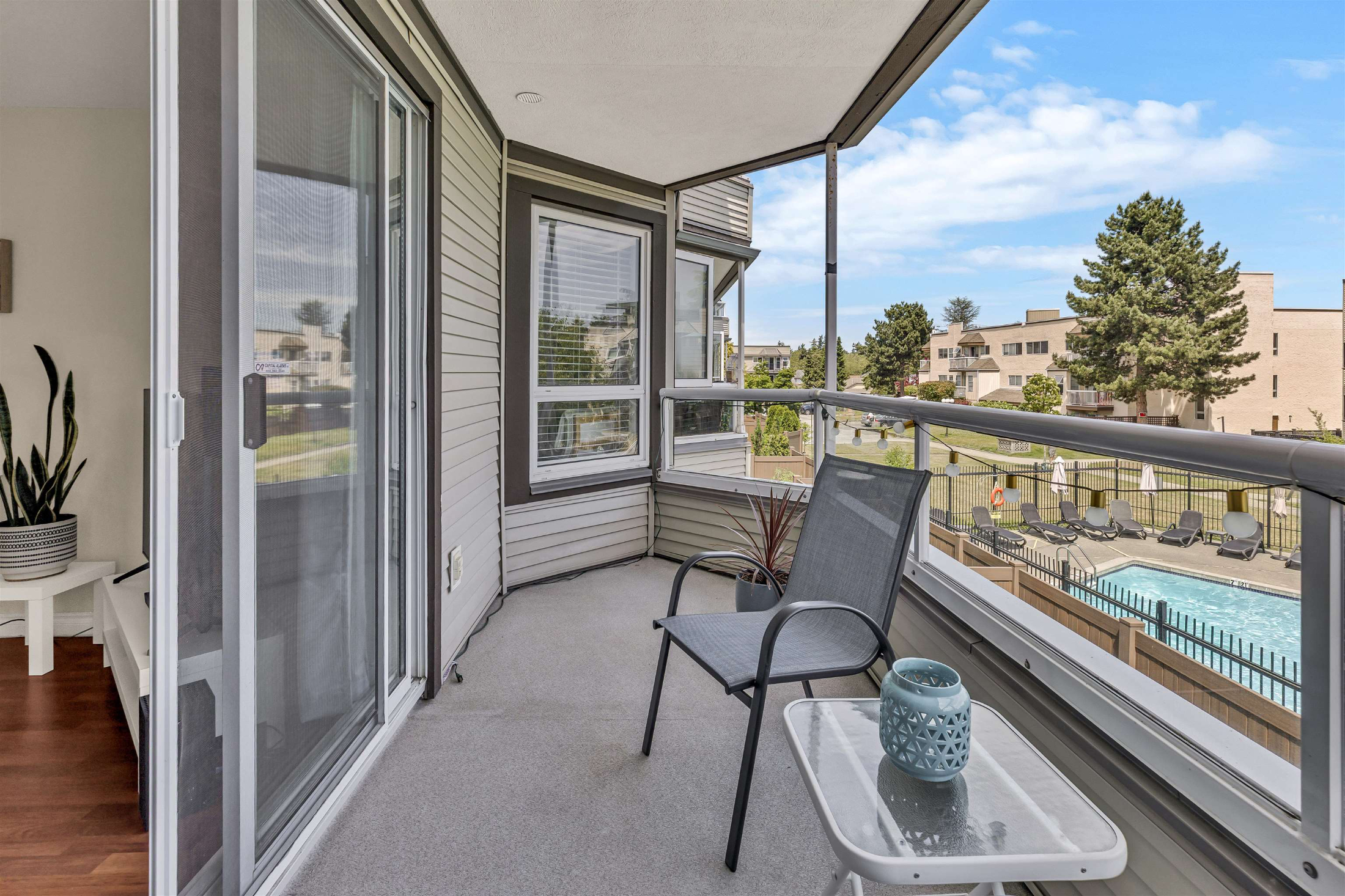 Private balcony with pool view and seating area.