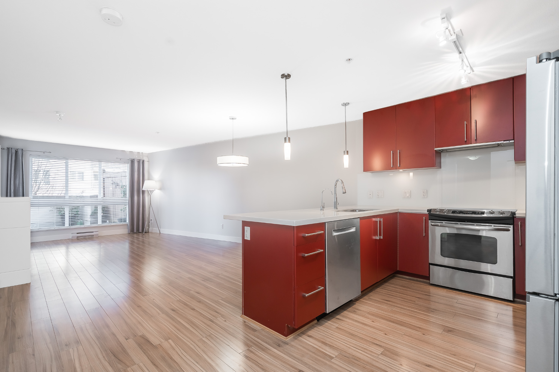 Open concept kitchen stainless steel appliances