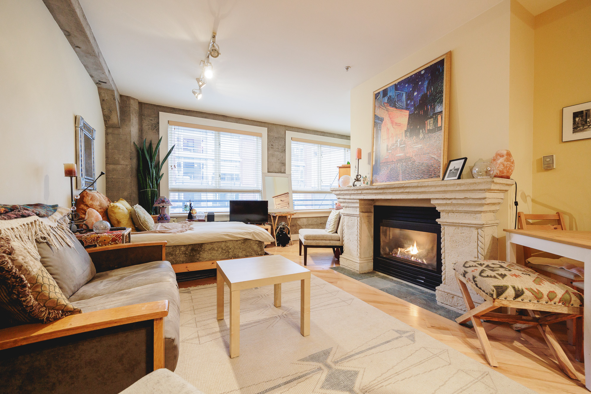 Exposed concrete beams and reclaimed fir floors inside a Yaletown loft condo