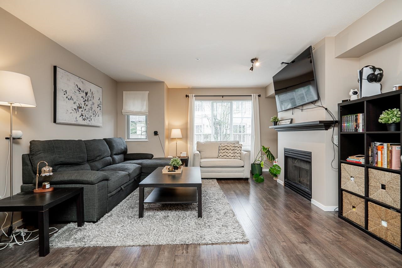 Bright open-concept main floor with gas fireplace at this sold Langley townhome.