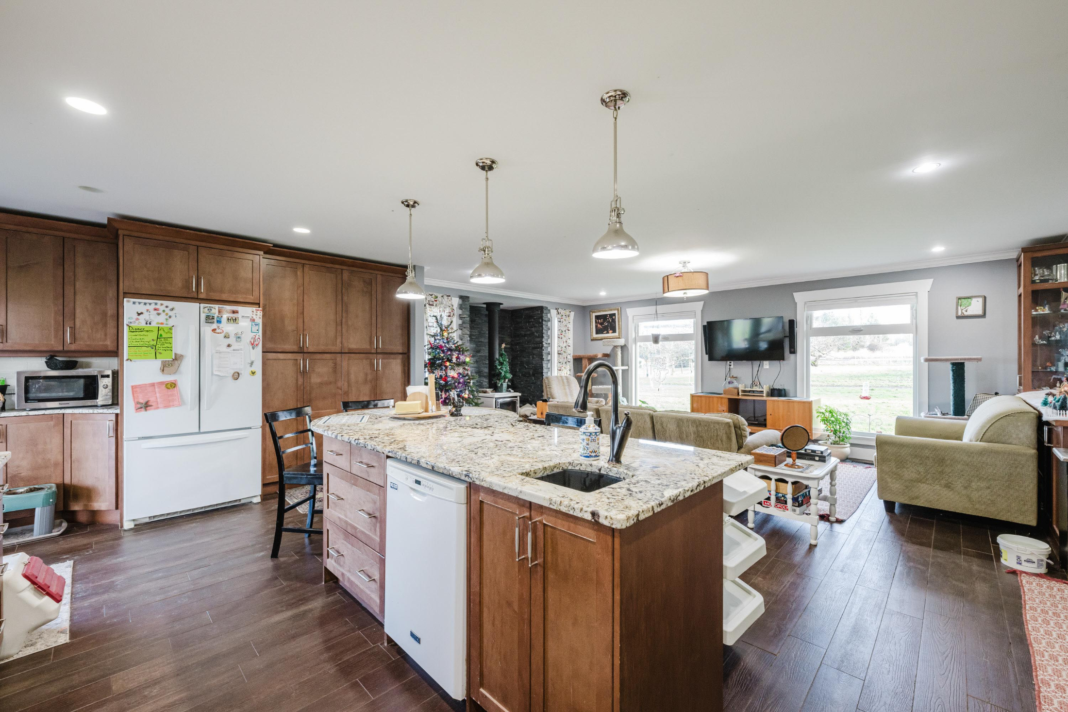 Open-concept kitchen with island and living area.